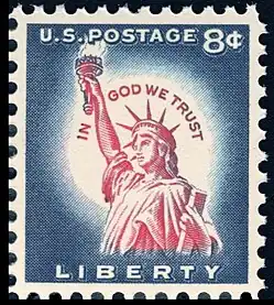 8¢ postage stamp from 1954, with the motto inscribed around the Statue of Liberty's head, in the white area surrounding her head. At the time, eight cents was the standard rate for international postage. A 3¢ (domestic mail rate) stamp with a similar design was also issued.