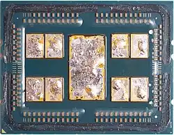 A delidded AMD 7702 featuring 8 CCDs and 1 I/O die, with remains of the solder thermal interface material (TIM) on the chiplets