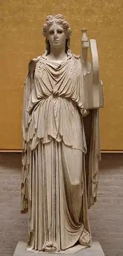 Statue of the god Apollo in the form of a young, smooth-faced man, holding a lyre in his left hand.