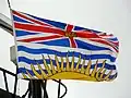 Flag of British Columbia showing a Union Flag, defaced with a gold crown, in the upper division