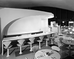 Union News restaurants coffee shop. designed by Raymond Loewy, which includes several stools facing a bar