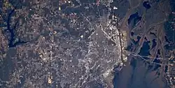 Large L-shaped lake miles West of Mobile as seen from space