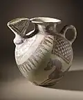 Bridge-spouted jar from Tepe Sialk, circa 800-600 B.C.; buff ware, creamslip, reddish-orange painted decoration. Height: 20 cm. Los Angeles County Museum of Art