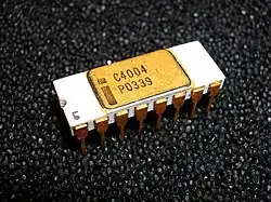 16-pin white ceramic DIP on black foam labeled with Intel logo and C4004