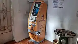 A photograph of an orange Athena Bitcoin cryptocurrency ATM