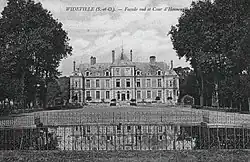 Black-and-white photograph of a château beyond a gated pond