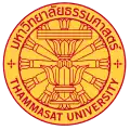 The seal of Thammasat University in Thailand consisting of a Constitution on phan with a twelve-spoked dhammacakka