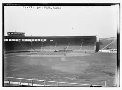 Black and white image of a baseball stadium circa 1914 with empty fields and grandstands