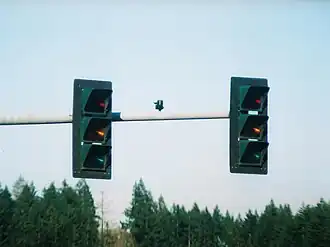 3M traffic signals in Shelton, Washington, as seen off-axis from the intended viewing area. These signals appear to be "off" or invisible to adjacent lanes of traffic during the daytime. Only a faint glow is visible at night.