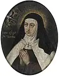 St Teresa of Avila, in a Carmelite habit, and with a halo of golden rays, clasps her hands in prayer as a white dove appears in the clouds.