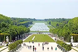 Image of a portion of the gardens of Versailles seen from in front of the palace's garden façade