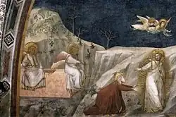 St. Mary Magdalene, kneeling, reaches out to Jesus, in white and gold robes, surrounded by golden light. Angels with pink and gold wings sit on the edge of the empty tomb, and fly above in a dark blue sky.