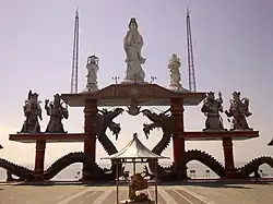 20-meter-high Guanyin Bodhisattva statue flanked by Longnü and Sudhana (top) Lower level shows the Four Heavenly Kings at Sanggar Agung, Surabaya, Indonesia.