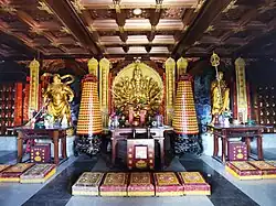 Statue of Qianshou Qianyan Guanyin flanked by the dharmapala Qielan on the right and the Bodhisattva Dizang on the left at the Guanyin dian of Zhaoshan Temple in Xiangtan, Hunan, China.