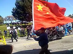 A man in San Francisco holding the Chinese flag during the torch relay for the 2008 Summer Olympics.