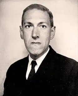 Portrait of man with black suit and tie, facing left and looking right