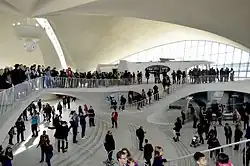 Visitors at the terminal in 2015, as seen from the upper level. There are large crowds on the footbridge across the intermediate level, as well as on the levels below.