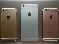 Reverse of three iPhones, showing the Apple logo
