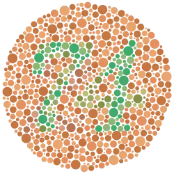 The number "74" – composed of scattered solid circles of varying size and varying but approximately green color – surrounded by a field of approximately sandy brown circles also of varying size and color. Some of the color variation in the circles is deliberately curated such that viewers with red-green color blindness will likely see the number "21" instead of "74".