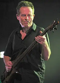Jones playing bass guitar in 2010