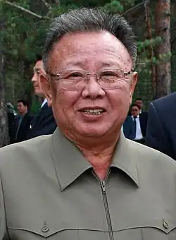 Head shot of Kim smiling and wearing a green jacket.