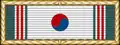 White ribbon with vertical green and red stripes on its edges and a red and blue circle in the middle