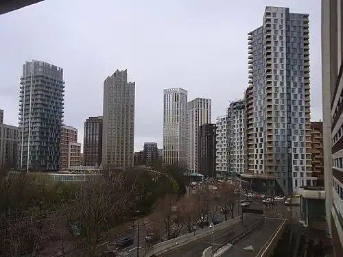 The emerging cluster in Lewisham also known as Lewisham Gateway, and first Borough of Sanctuary,[518] which includes 209 Connington Road Tower at 117&nbsp;m tall which is the white building in the centre and Lewisham Exchange at 105&nbsp;m tall to the left of it. All of the high-rises shown in this picture are residential with the exception of the grey building shown in the immediate right foreground which was formerly the London offices of Citigroup until they relocated to 25 Canada Square at Canary Wharf in 2001