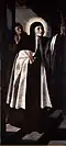St. Teresa of Avila, in a Carmelite habit, and with a halo of golden rays, holds a crucifix aloft.