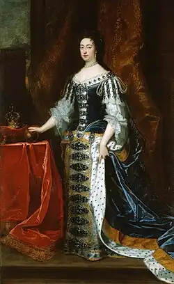 Painting of Mary. An orb is on the table to her right, as is the crown, which is placed on a cushion.