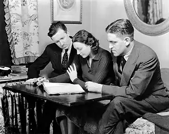 Guthrie McClintic, Katharine Cornell and Sidney Howard photographed in Cornell's dressing room at the Belasco Theatre, studying Howard's play Alien Corn. Directed by McClintic, Cornell's production of the play opened February 20, 1933.