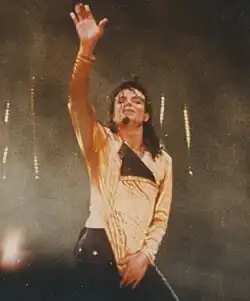 Black and white photo of Jackson holding a microphone and singing.