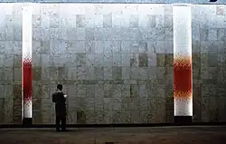 Travertine walls together with op art ceramic mosaics by Wojciech Fangor in Warszawa Śródmieście railway station in Warsaw, Poland (1963).