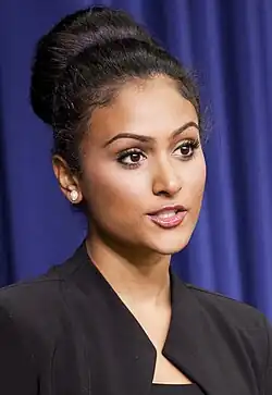 Davuluri standing at a podium
