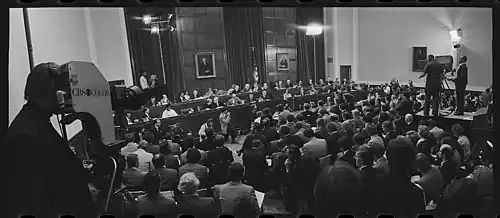 Impeachment proceedings, with live television cameras on either side of an audience before the seated committee members