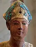 Wooden statue of Amenhotep I that was usurped by Ramses II wearing the Khepresh, now at the Louvre E 16277, Paris.[52]