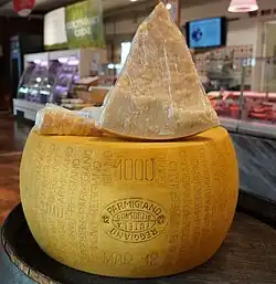 A wheel and three slices of Parmesan