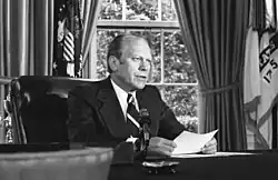 President Ford at his desk in the Oval Office announcing his pardon of Nixon on September 8, 1974