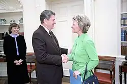 Phyllis Schlafly (center right) and President Ronald Reagan (center left) shake hands in the Oval Office.