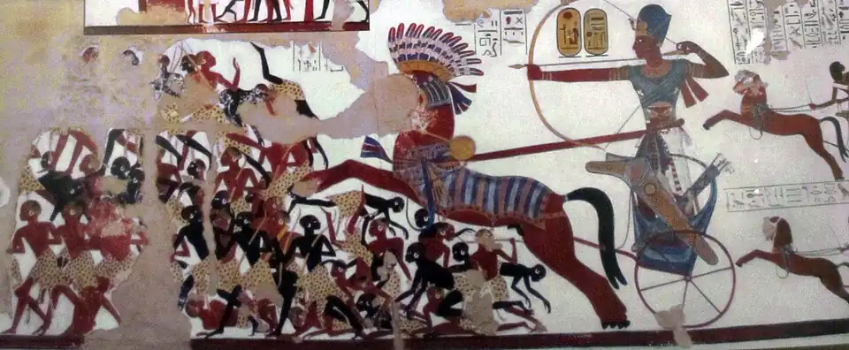 Ramesses II in his war chariot charging into battle against the Nubians. New Kingdom reliefs as seen in Rameses II temple, Beit el-Wali, represented Nubians with dark reddish brown and jet black skin tones.[243]