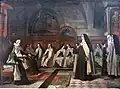 St. Teresa of Avila, wearing a Carmelite habit, and with a gold halo, addresses her spiritual director, surrounded by Carmelite sisters.