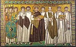 A 6th-century mosaic in Ravenna, showing Justinian with the bishop Maximianus, bodyguards, and courtiers.