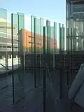Three parallel rows of see-through glass plates