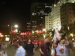 group of people outdoors at night on a city street