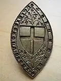 14th-century brass stamp with the shield insignia