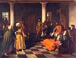 Two bearded men, each wearing a turban, stand before a man who sits on a throne; a dozen people surround them