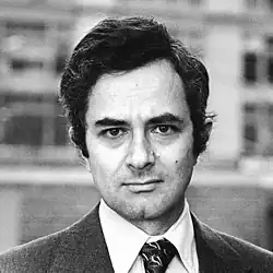 Black-and-white photo of a man with dark hair wearing a tie
