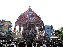 a temple car drawn by a lot of people