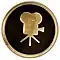 Circular 4-inch brass plaque showing a side view of a classic movie camera.