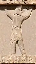 Engraving of a man wearing a helmet with a short sword in his cummerbund