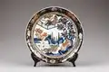 Japanese Imari ware dish with landscape, figures, and floral decoration in underglaze blue, iron-red, and gold, early 18th century. Hallwyl Museum, Stockholm.